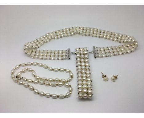 A cultured pearl necklace and pearl bracelet plus a pair of pearl earrings with 9ct gold fastenings.