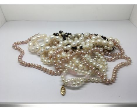 A collection of cultured pearl necklaces. Some with gold clasps.
