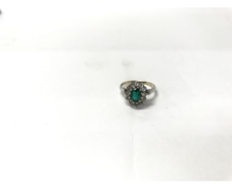 A silver and 9ct gold shank ring with emerald coloured stone. Weight approx 2.1g, size approx M