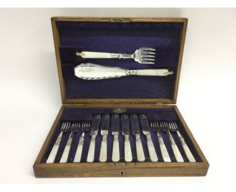 An oak cased set of mother of pearl handled silver plate cutlery, marked to the reverse M L J, retailed by Daniel Todd of Gla