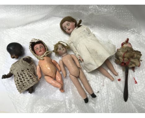 A bisque puppet doll with four other dolls.