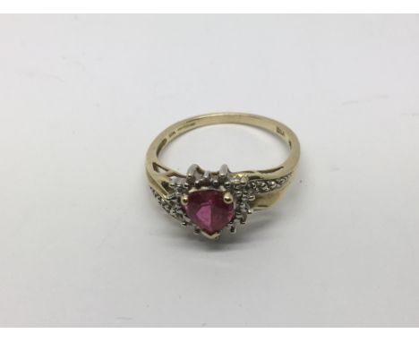 A 10k gold ring set with a heart shaped pink stone surrounded by diamonds, approx 2.6g and approx size S.