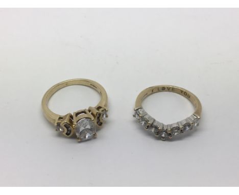 Two 9ct gold rings comprising a stone set wishbone ring, approx 2.5g and approx size L and a fancy ring, approx 3.6g and appr