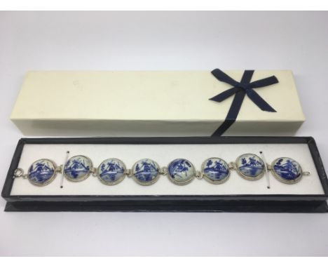 A silver and ceramic Delft bracelet decorated with typical images of windmills.