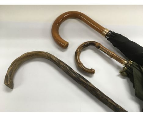 An umbrella with 18ct gold band plus one other umbrella, a walking stick and a copper coal bucket.