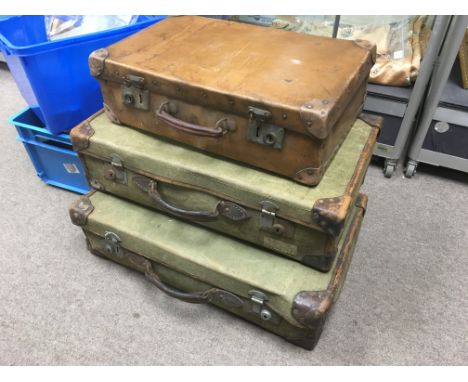 Three vintage suitcases.