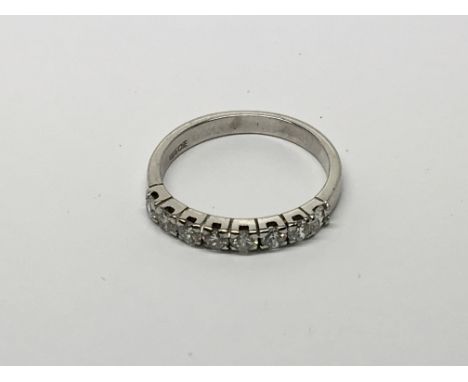 A Ladies 14ct white gold ring set with a row of brilliant cut diamonds total carat weight0.65.ring size M.