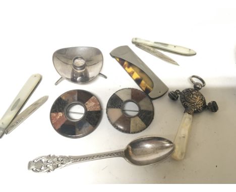 A Silver childs rattle two silver and mother of pearl fruit knifes two Scottish polished pebble brooches and other oddments.