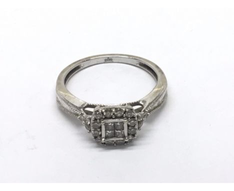 A white gold diamond cluster ring. ring size M.