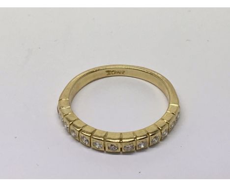 An 18carat yellow gold ring half hoop set with a single row of brilliant cut diamonds. Ring size M.