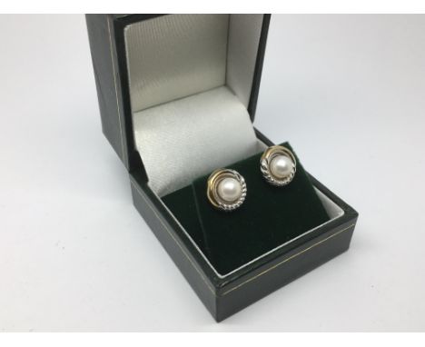 A pair of 9ct gold and cultured pearl stud earrings.