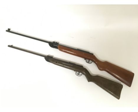 Two vintage air rifles and a military jacket.