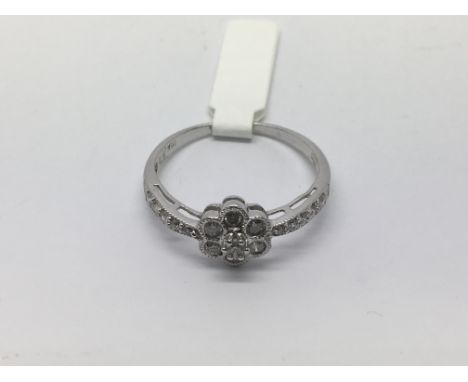 A white gold diamond cluster ring set with a central flowerhead, approx half carat, approx 3g and approx size V-W.