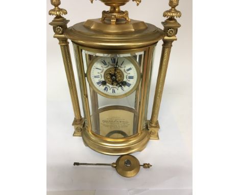 A Victorian four glass mantle clock the enamel dial with Roman numerals and visible pendulum with classical influences engrav