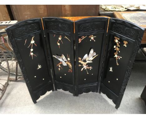 An oriental lacquer wood folding screen appliecwith mother of pearl decoration, approx 27x90cm, folded