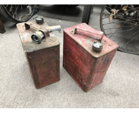 Two vintage oil cans and an early tyre pump.