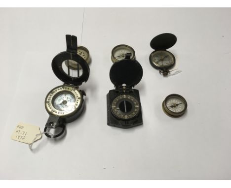A collection of 6 compasses to include a Barker 1972 M-71 and a Barker shallow Hunter compass