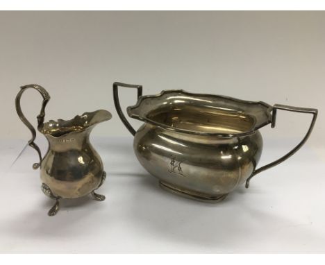 A two handled silver sugar bowl and a small silver jug, both with Bormingham hallmarks plus a Middle Eastern white metal comp