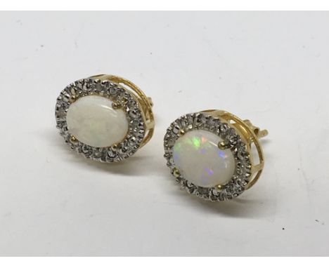 A pair of opal and diamond earings. Possible silver gilt