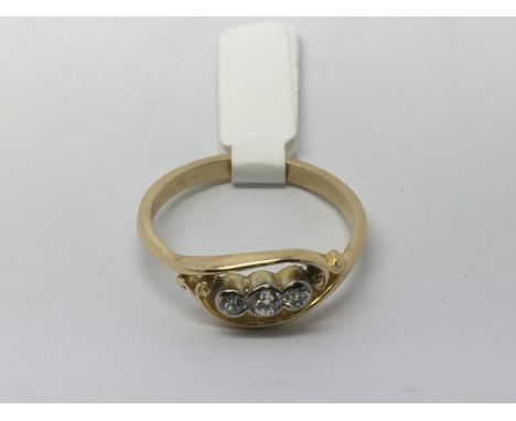 An unusual diamond three stone ring set in gold, approx 3.5g and approx size S.