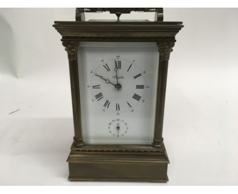 A French brass carriage clock with alarm push button repeat ,visible platform escapement , the dial with Roman numerals and s