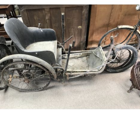 A vintage three wheeled mobility scooter propelled by moving the arms.