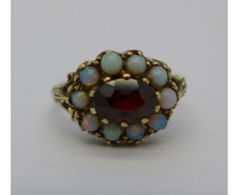A 9ct gold, garnet and opal ring, 2.7g, K