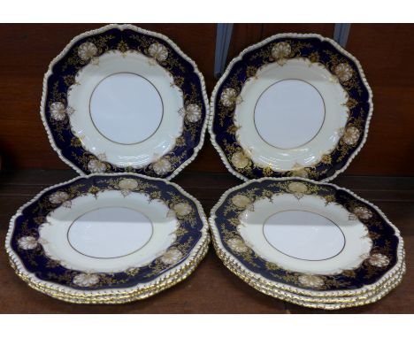 Eight Royal Worcester plates with gilt and dark blue border decoration