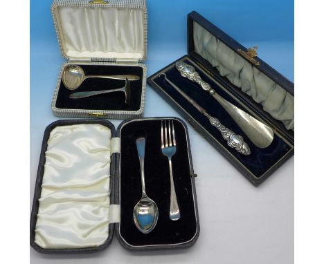 Two cased silver christening sets, 61g, and a cased button hook and shoe horn