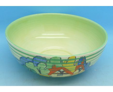 A Clarice Cliff bowl decorated with red roof houses, trees and green, yellow and blue bands, 11cm