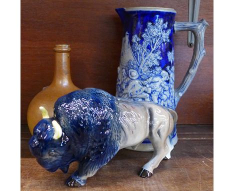 A continental stoneware relief moulded jug, bottle vase and a Melba ware buffalo