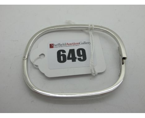 A Modern 9ct White Gold Bangle, of rounded rectangular plain design, hinged to snap clasp (7grams).  