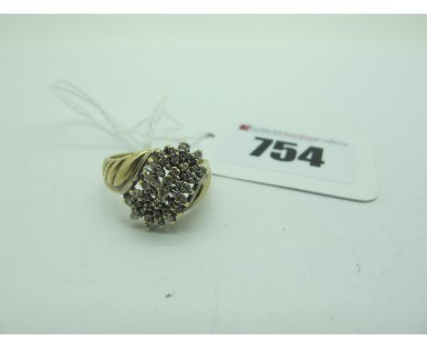 A Modern 9ct Gold Cluster Dress Ring, of abstract design, claw set (finger size O) (4.2grams).  