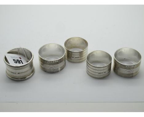 Two Pairs of Hallmarked Silver Napkin Rings, with engine turned decoration; together with another, initialled (total weight 1