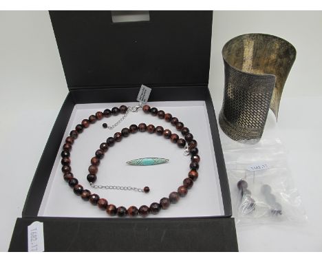 A Large Niello Style Cuff Bangle, (9.6cm long); a modern red tigers eye faceted bead necklace and matching bracelet (clasps s