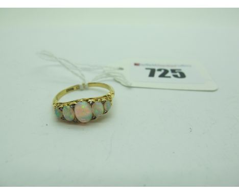 A Five Stone Opal Ring, scroll carved set with five graduated oval cabochons, with diamond chip highlights, (indistinctly sta