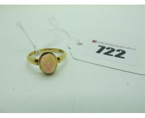 A Single Stone Opal Ring, oval cabochon set, within plain setting, stamped "18ct" (finger size O1/2) (3.1grams). 