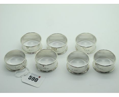 A Set of Six Hallmarked Silver Napkin Rings, (some marks rubbed) of plain design; together with another hallmarked silver nap