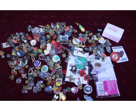 A large selection of assorted enamel badges 
