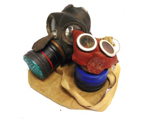 TWO SECOND WORLD WAR CIVILIAN GAS MASKS  including a child's 'Mickey Mouse' example, the interior moulded 'HO 141 / L. &amp; 