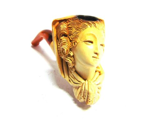 A MEERSCHAUM PIPE  the bowl carved with an inclined lady's head wearing a heavily folded scarf, with an amber mouthpiece, 10c