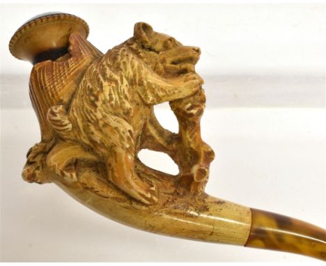 A MEERSCHAUM CHEROOT HOLDER  the stem carved with a bear on its hind legs gnawing at a trunk, with an amber mouthpiece, 11.5c