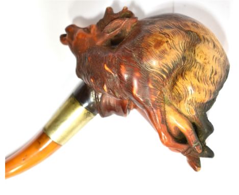 A MEERSCHAUM PIPE  carved in the form of a hand holding a deer trophy with bound hooves, with an amber mouthpiece, 12cm long,