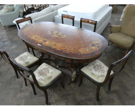 An oval Italian style floral topped refectory style dining table on heavy base with rams head and paw feet, together with six