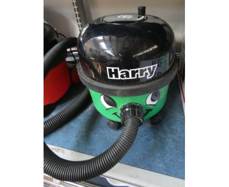 A green Henry Numatic Hoover with tools 