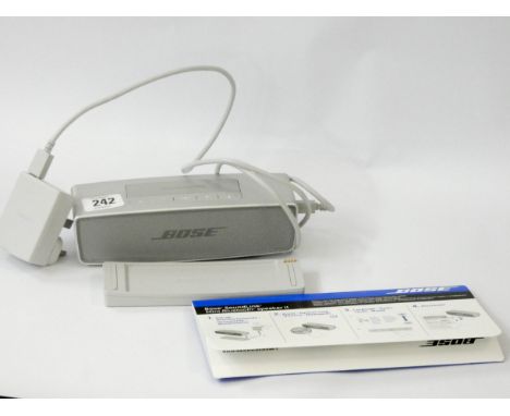 A Bose Soundlink Mini Bluetooth Speaker II with power cable and instructions