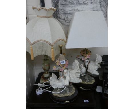 A pair of white dove table lamps and an onyx table lamp with two shades