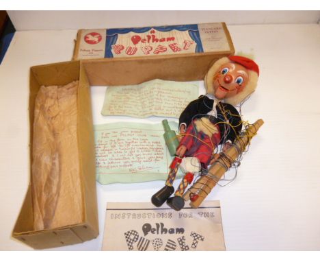 A Pelham Puppet 'Macboozle', with round wooden head, black velvet jacket and tartan kilt and bottle and instructions, in orig