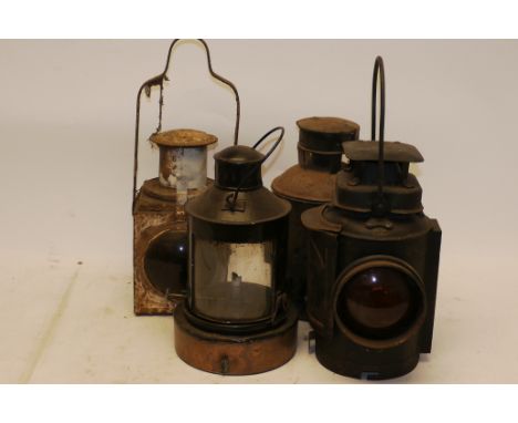 A Group of Oil-Lit Signal and Other Lamps, four assorted lamps including BR(E) tail lamp, P with cracked lens, an Adlake ambe