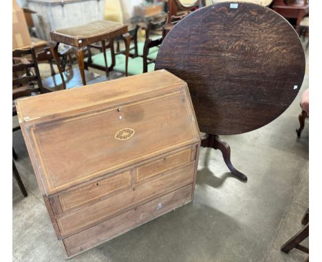A George III oak tripod tilt top table and an inlaid mahogany bureau 